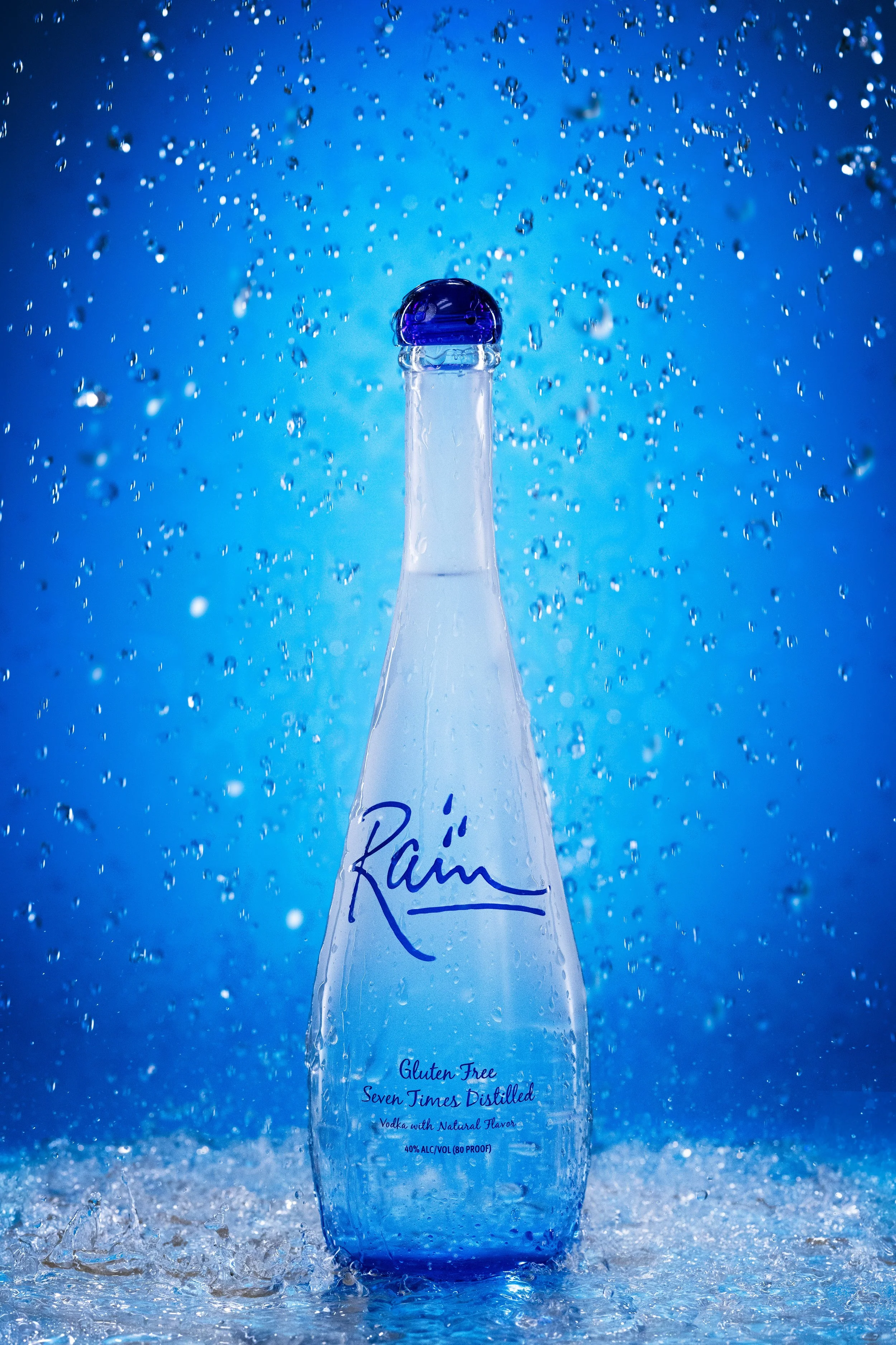 Rain sparkling water bottle splashing against a blue background