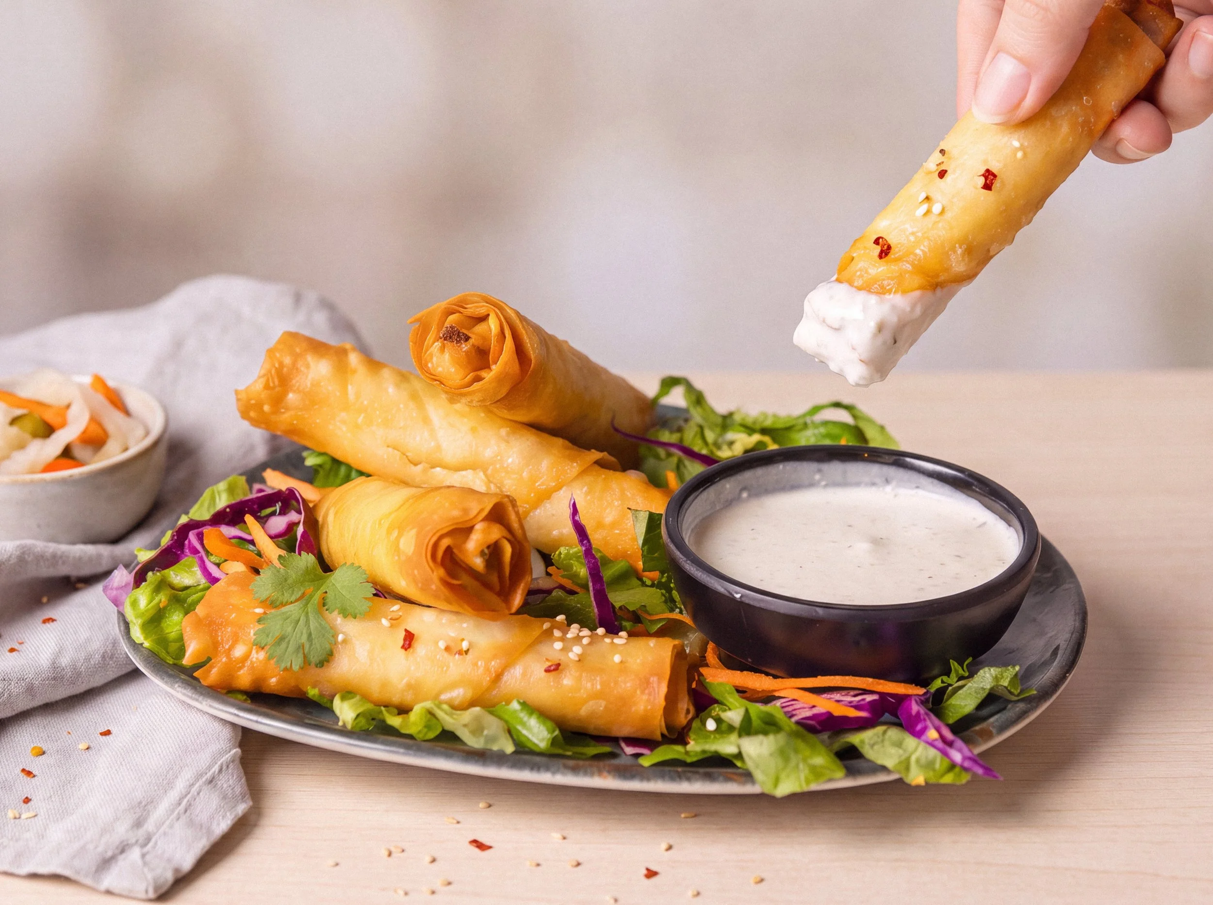 Fried spring rolls with dipping sauce and cabbage slaw