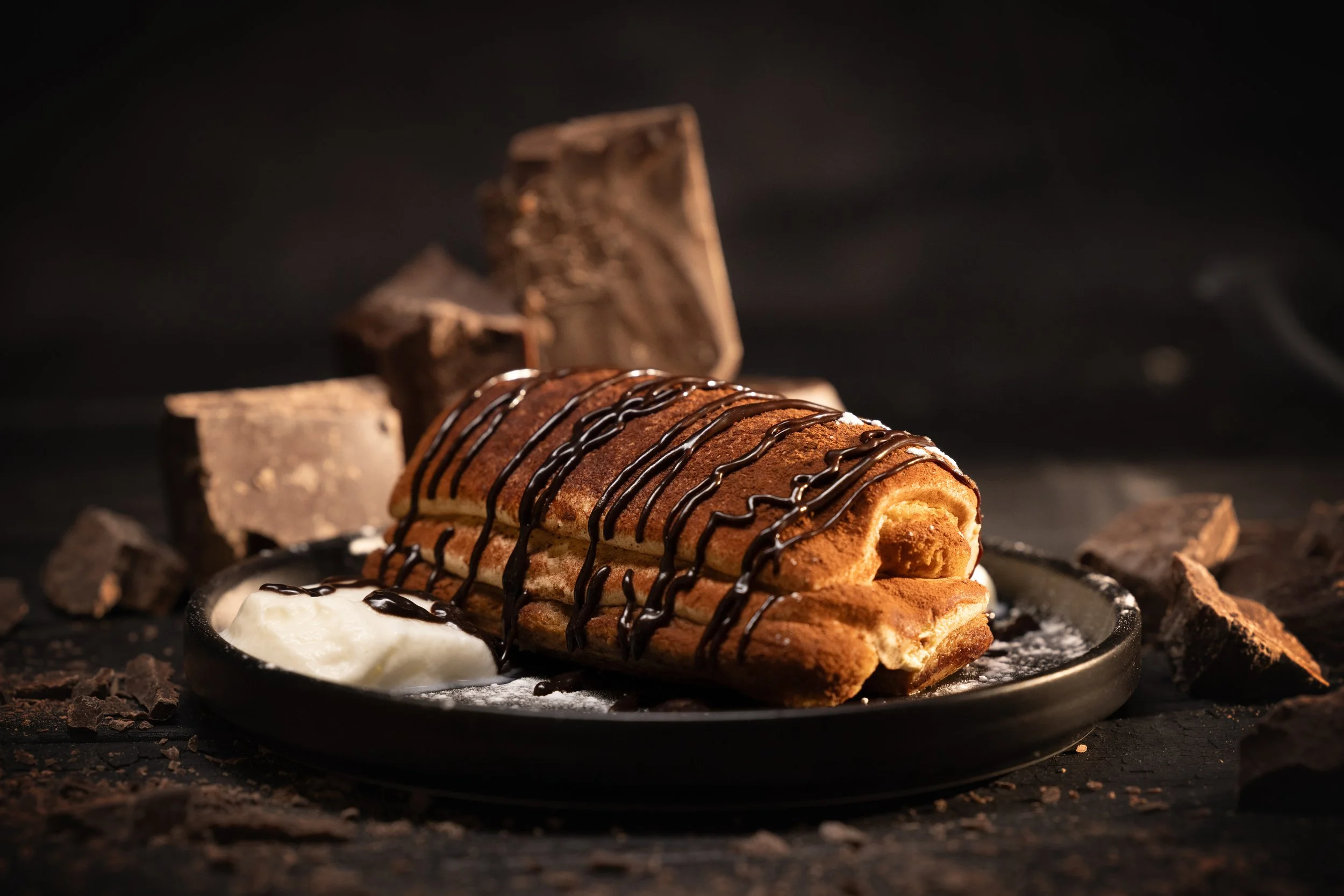 Chocolate-drizzled pastry roll with ice cream and chocolate chunks