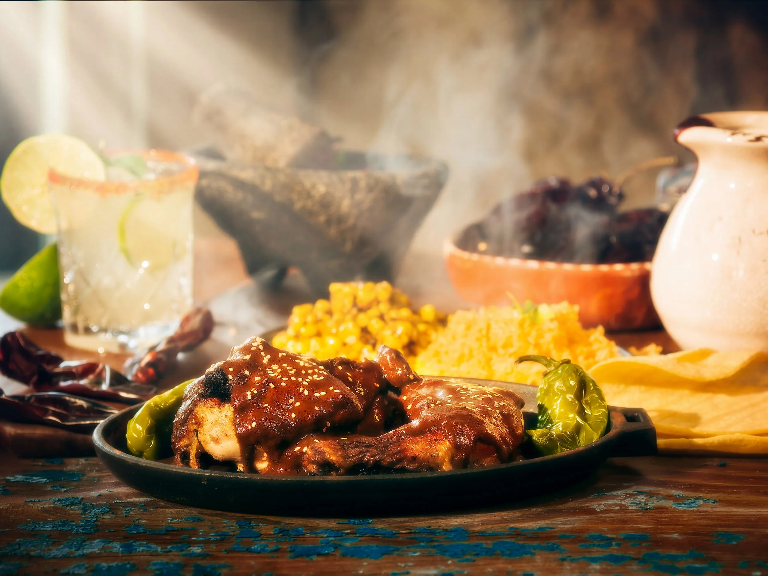 BBQ chicken platter with corn, a margarita, and rising steam