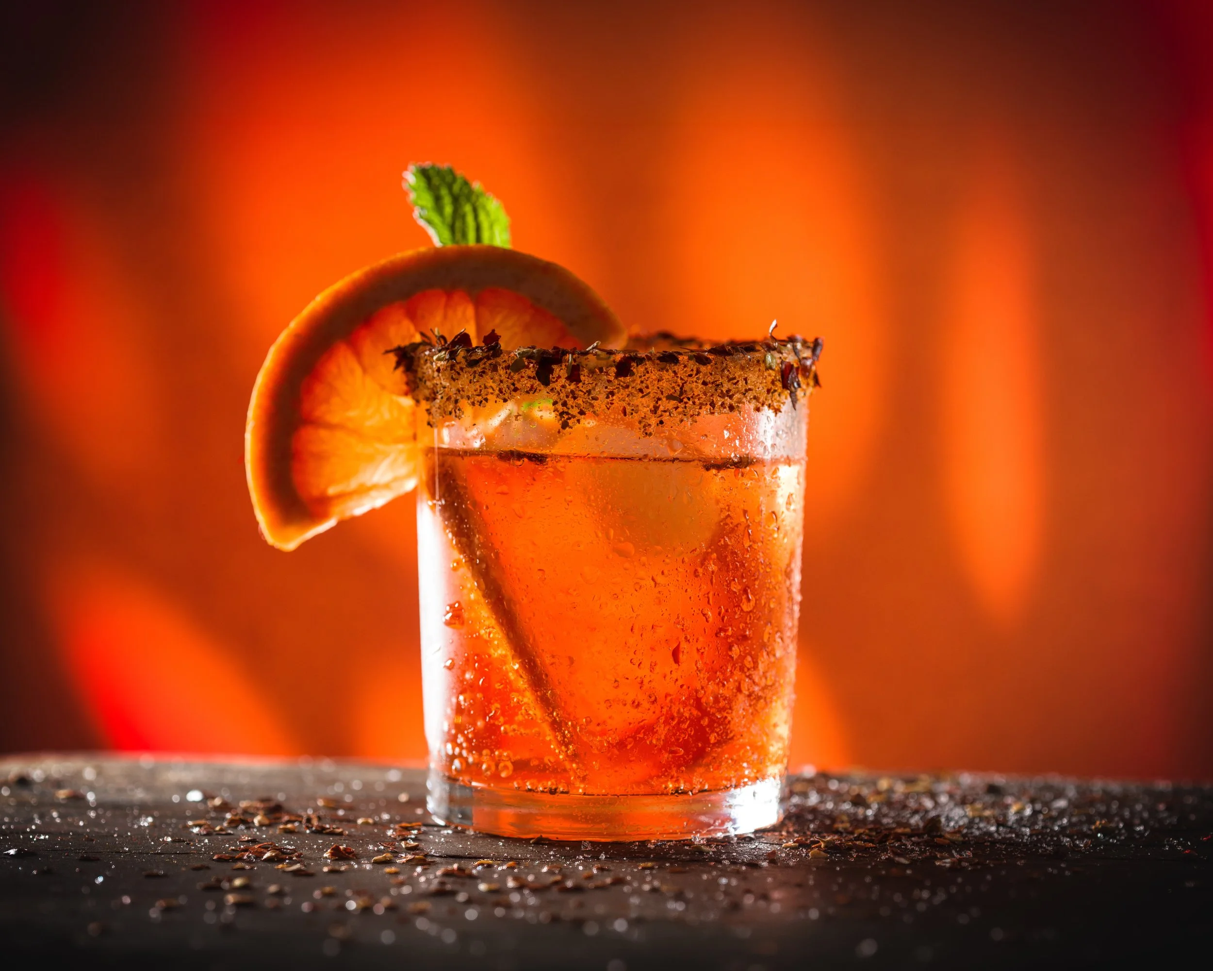 Spicy margarita with an orange slice and chile salt rim